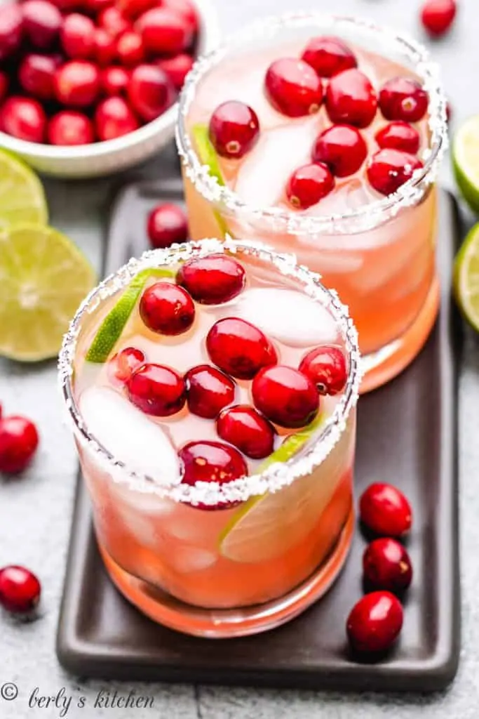 Two seasonal cocktails on a serving tray.