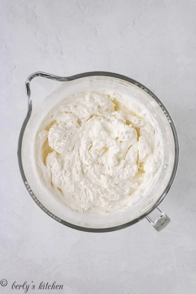 Whipped cream in a large mixing bowl.