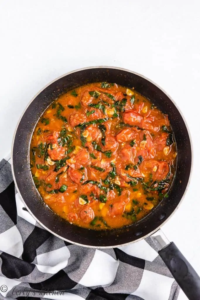 The pasta sauce thickening as it cooks down.