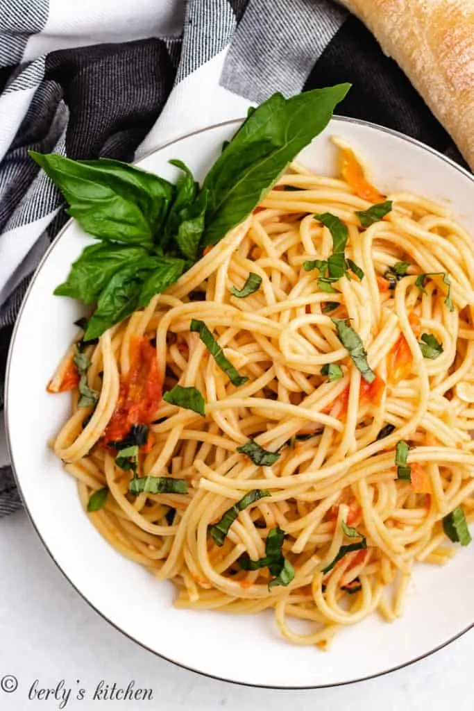 Tomato basil pasta in a white serving dish.