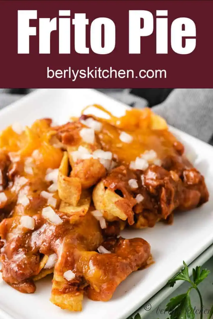 Frito pie served with shredded cheddar cheese and onions.