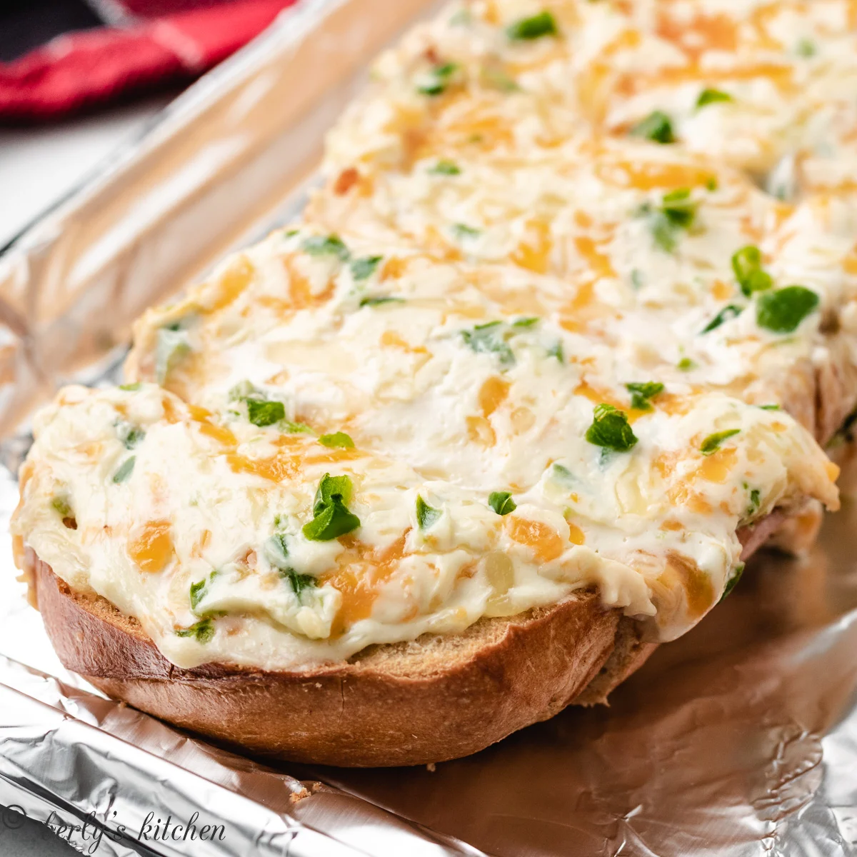 The fresh baked jalapeno popper bread on a lined sheet pan.