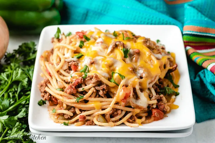 Mexican spaghetti on white plates.