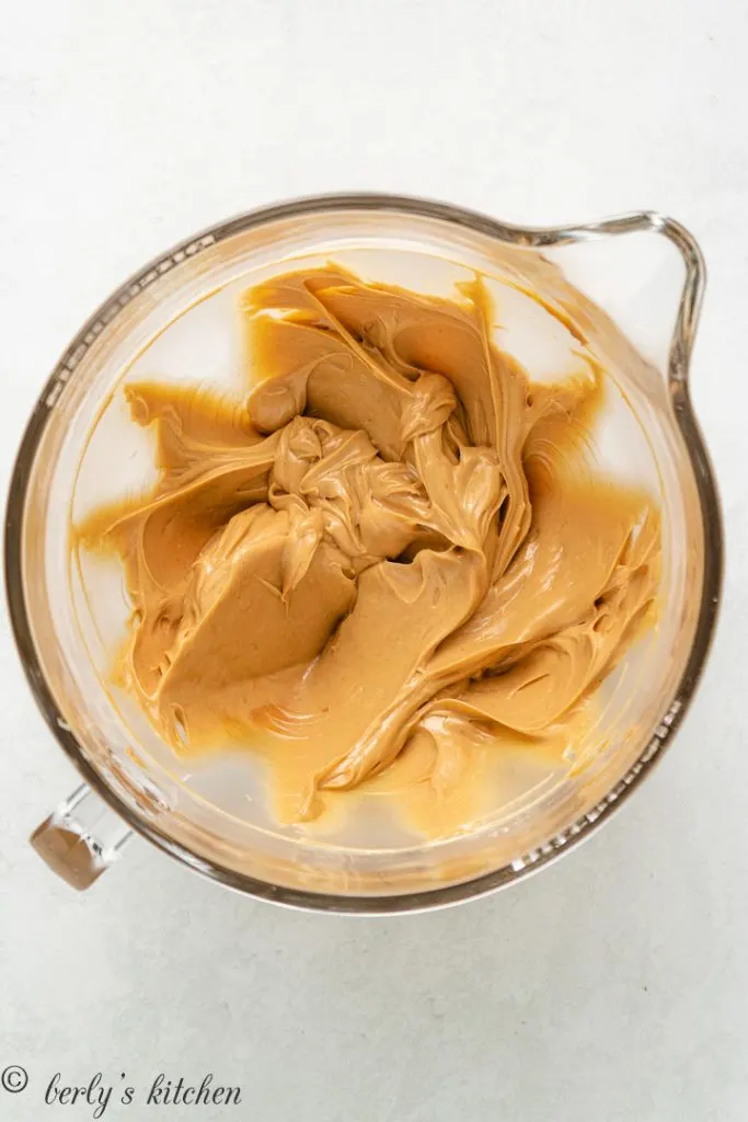 Unsalted butter and peanut butter combined in a mixing bowl.