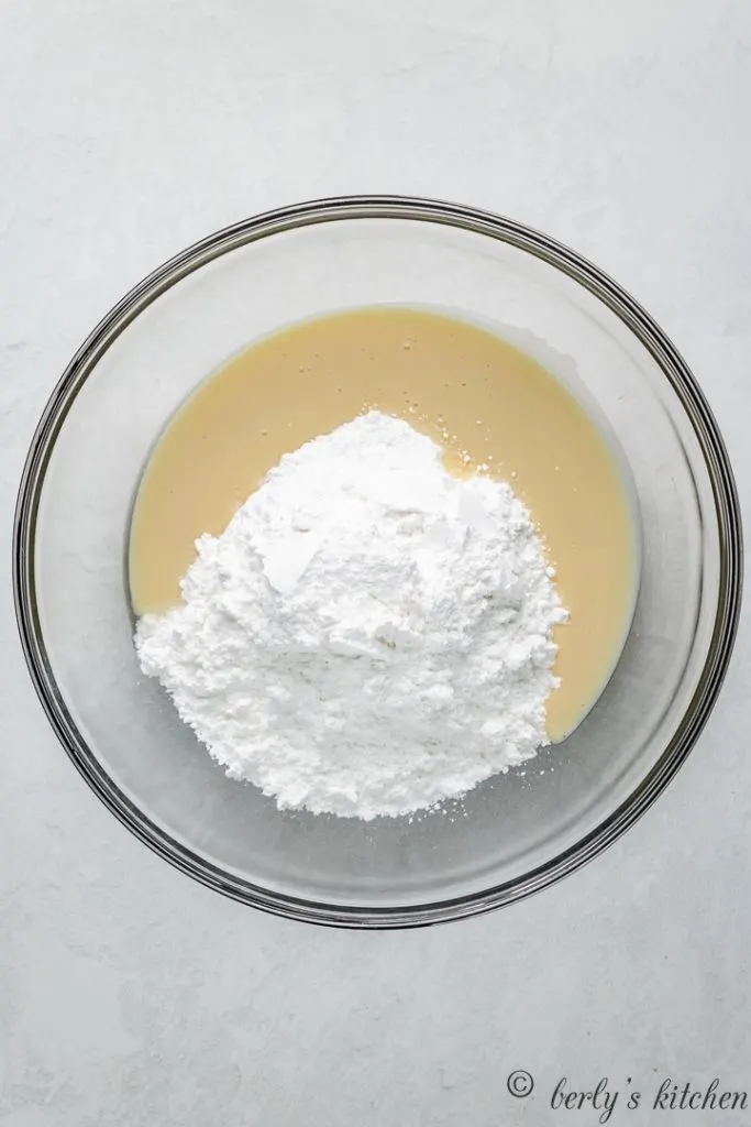 Powdered sugar and other ingredients in a mixing bowl.