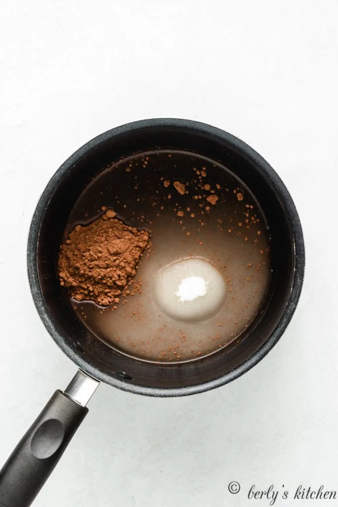 Cocoa powder, sugar, and water, in a saucepan.