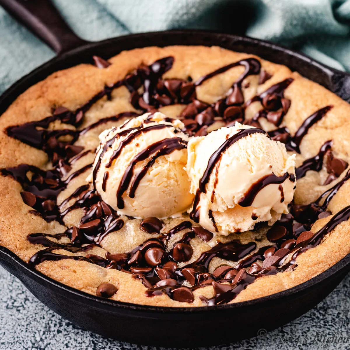 Mini skillet cookie with ice cream and chocolate syrup.