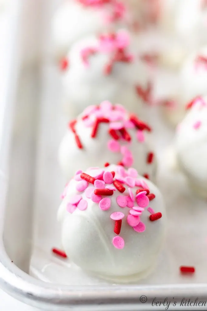 Red velvet truffles on a baking sheet.