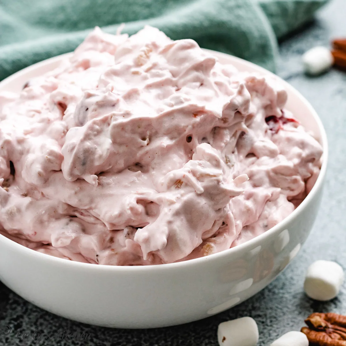 Cherry salad in a dish with a towel.