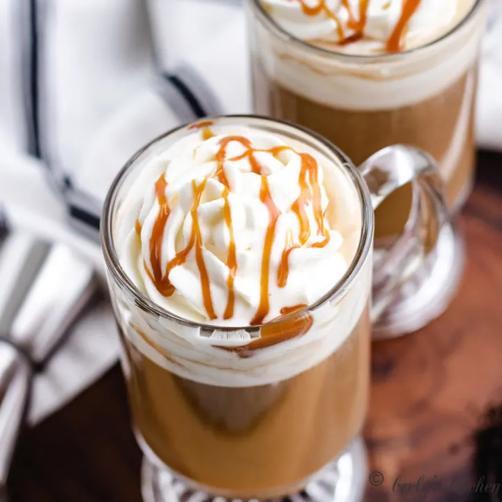 Top down view of whipped cream with caramel sauce on top of coffee.