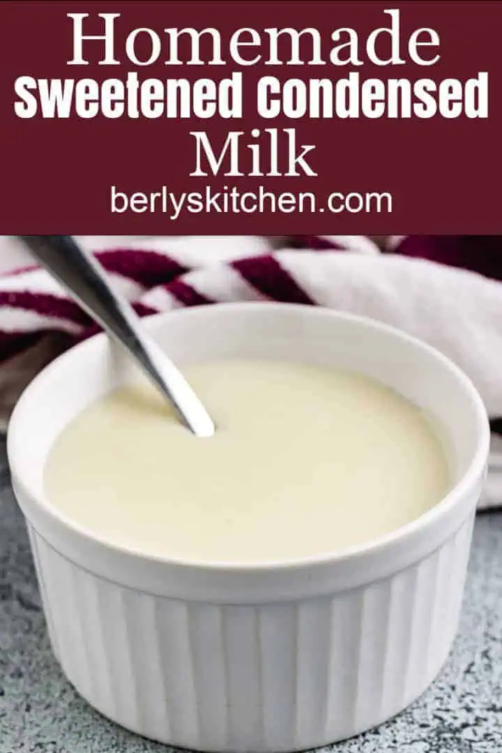 Sweetened condensed milk in ramekin with a spoon.