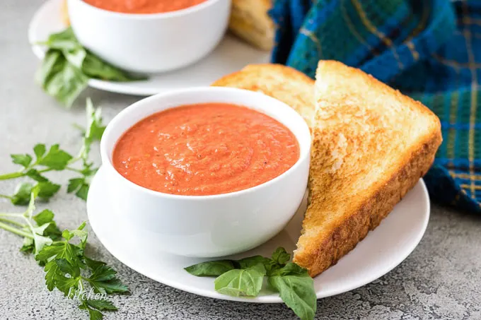 The tomato basil soup served with a grilled cheese sandwich.