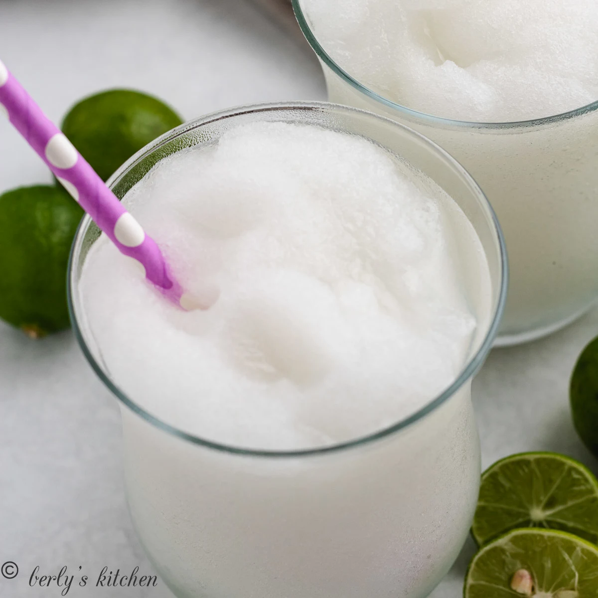 Close up view of a frozen daiquiri with a colorful straw.