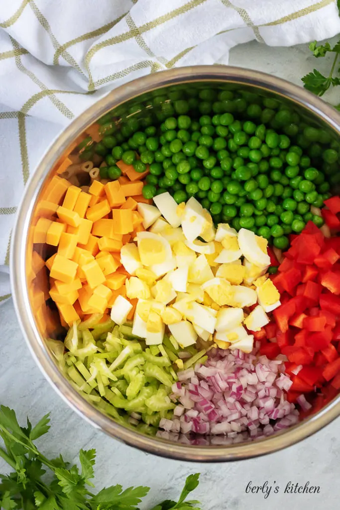 The vegetables have been added to the pressure cooker for mixing.