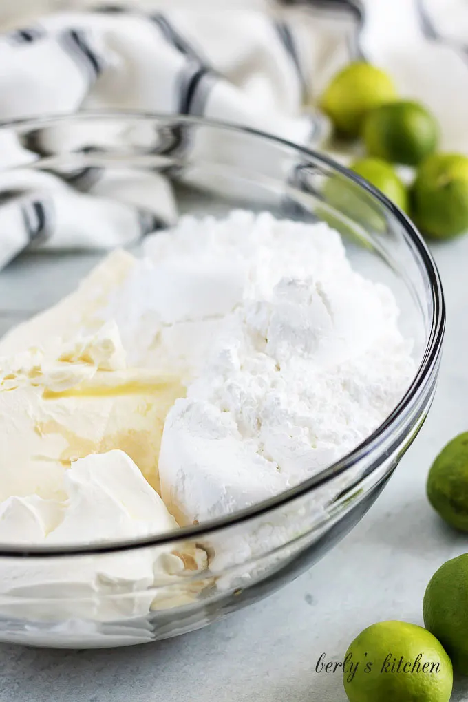 Powdered sugar, cream cheese, and key lime juice in a mixing bowl.