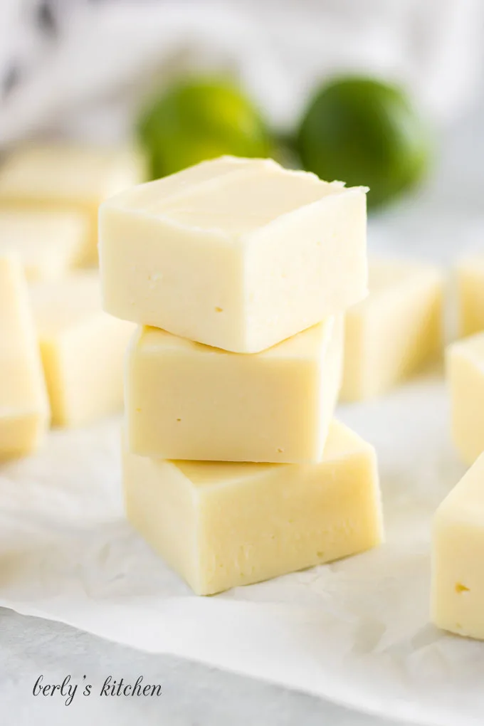 Three pieces of key lime fudge in a stack.