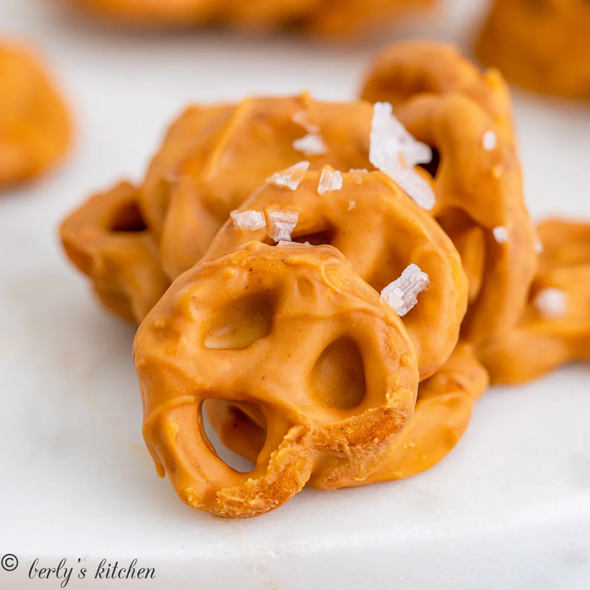 Salted peanut butter pretzel cookie on white paper.