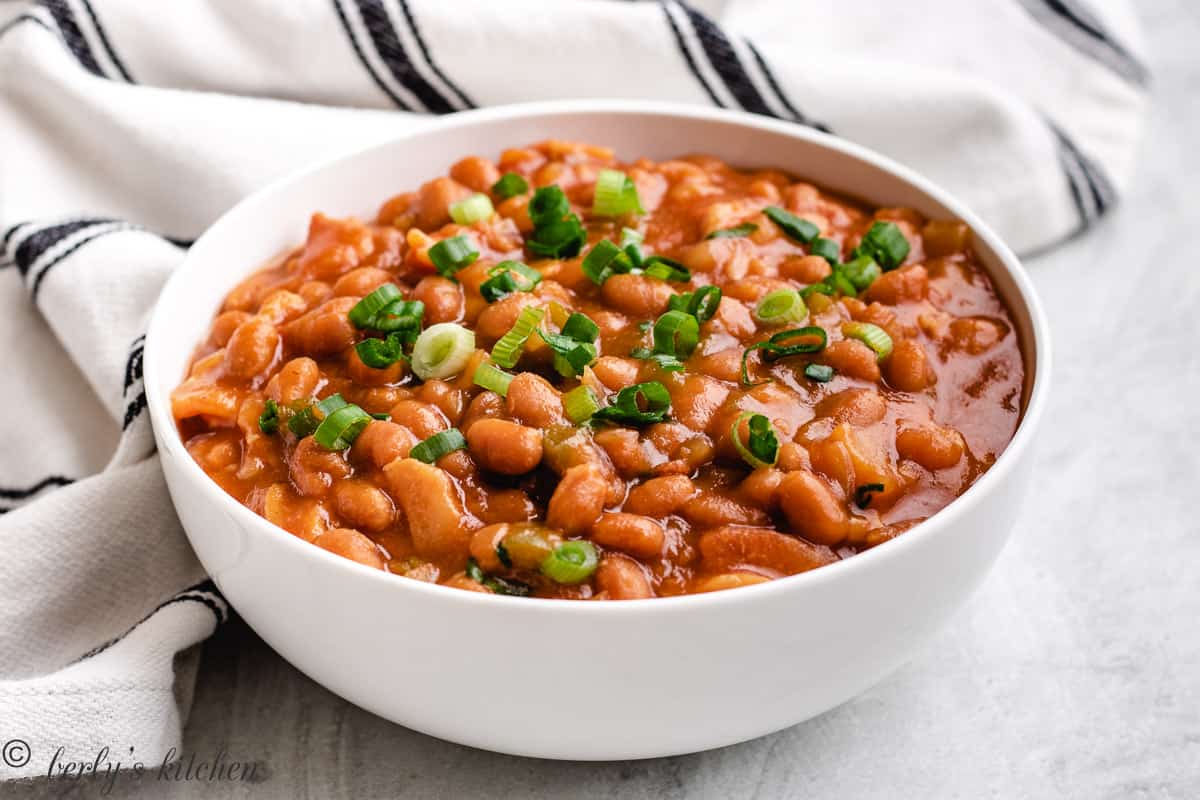 Large white bowl filled with slow cooker baked beans.