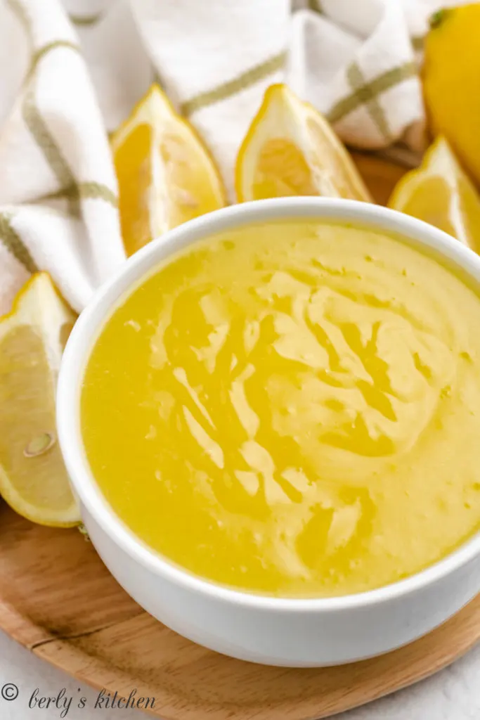 Top down view of lemon curd in a white bowl.