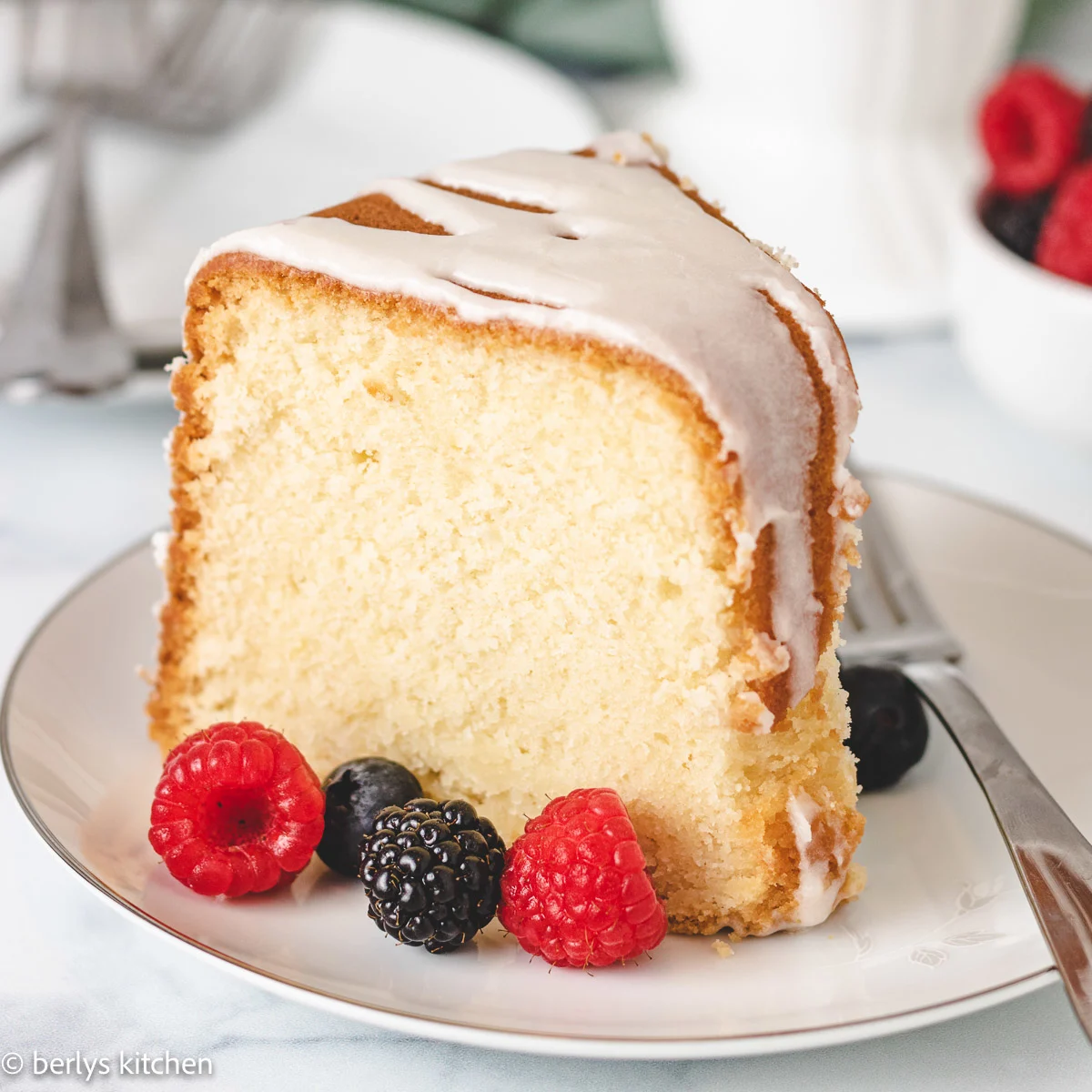 Slice of lemon pound cake with fresh berries.