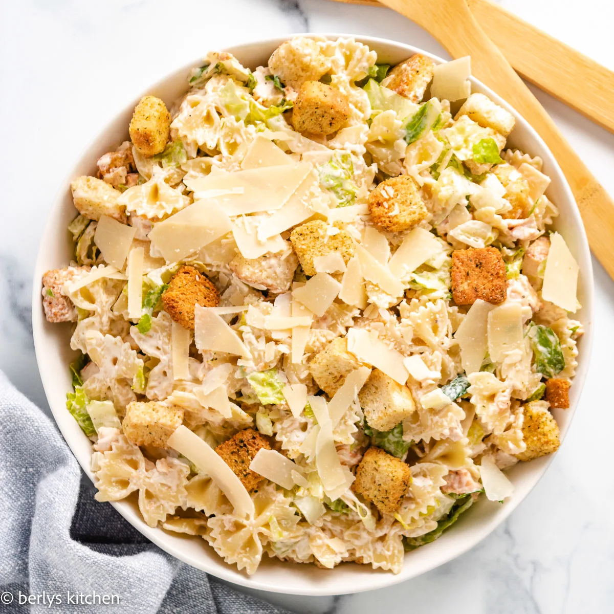 Chicken caesar pasta salad in a serving dish.