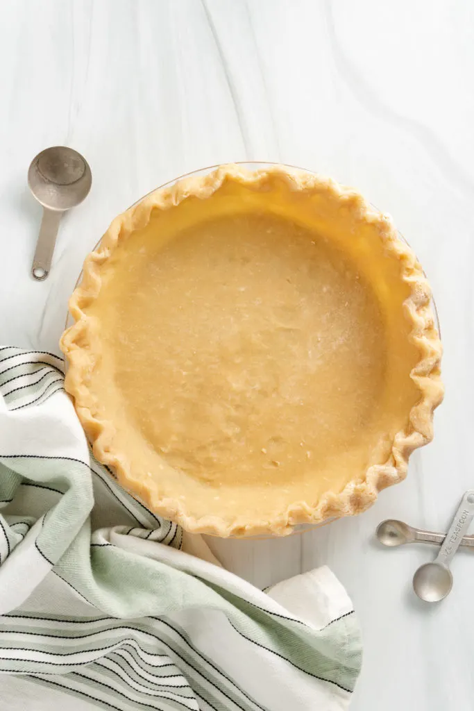 Top down view of pie shell in a dish.