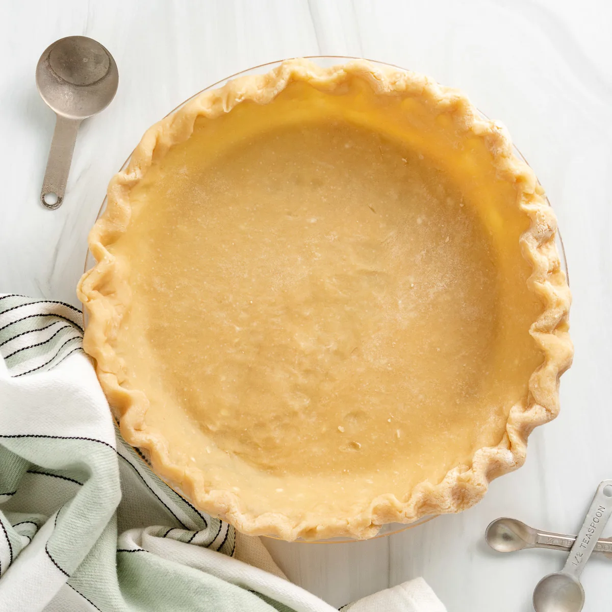 Top down view of pie dish with pie crust.