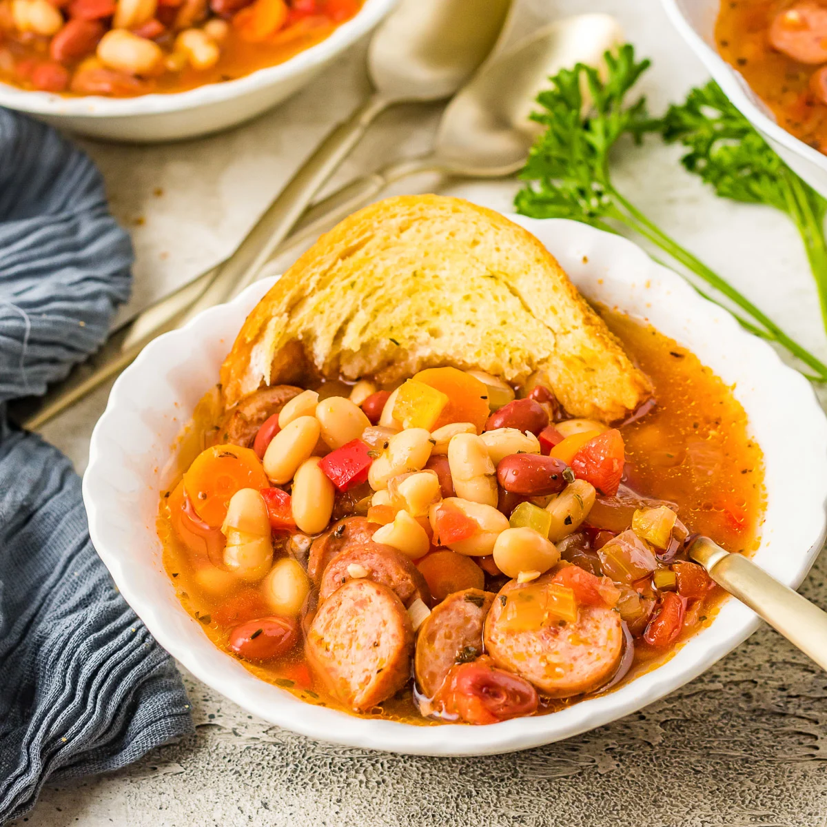 Bowls filled with slices of bread and bean soup.