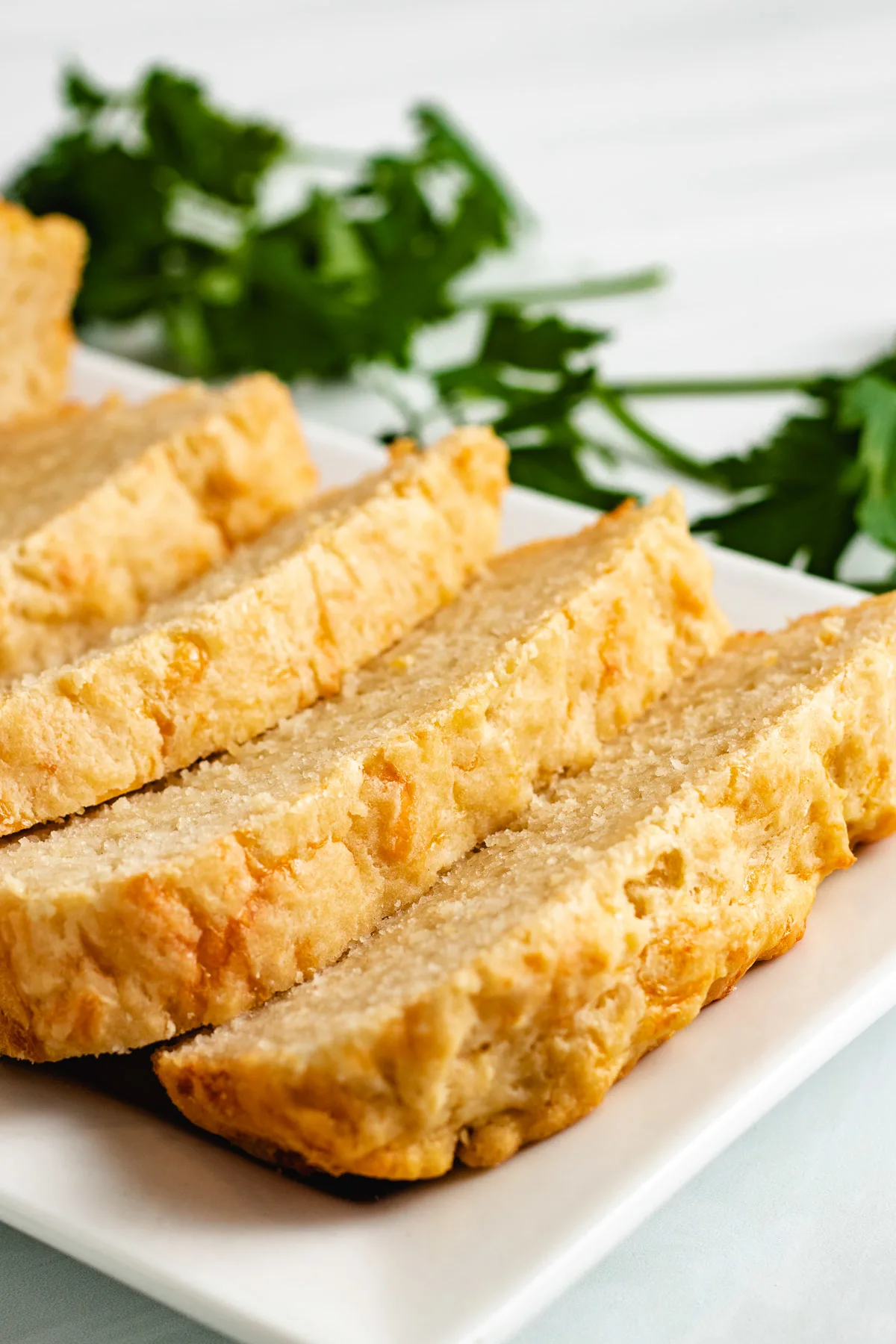 Sliced beer bread on a white platter.