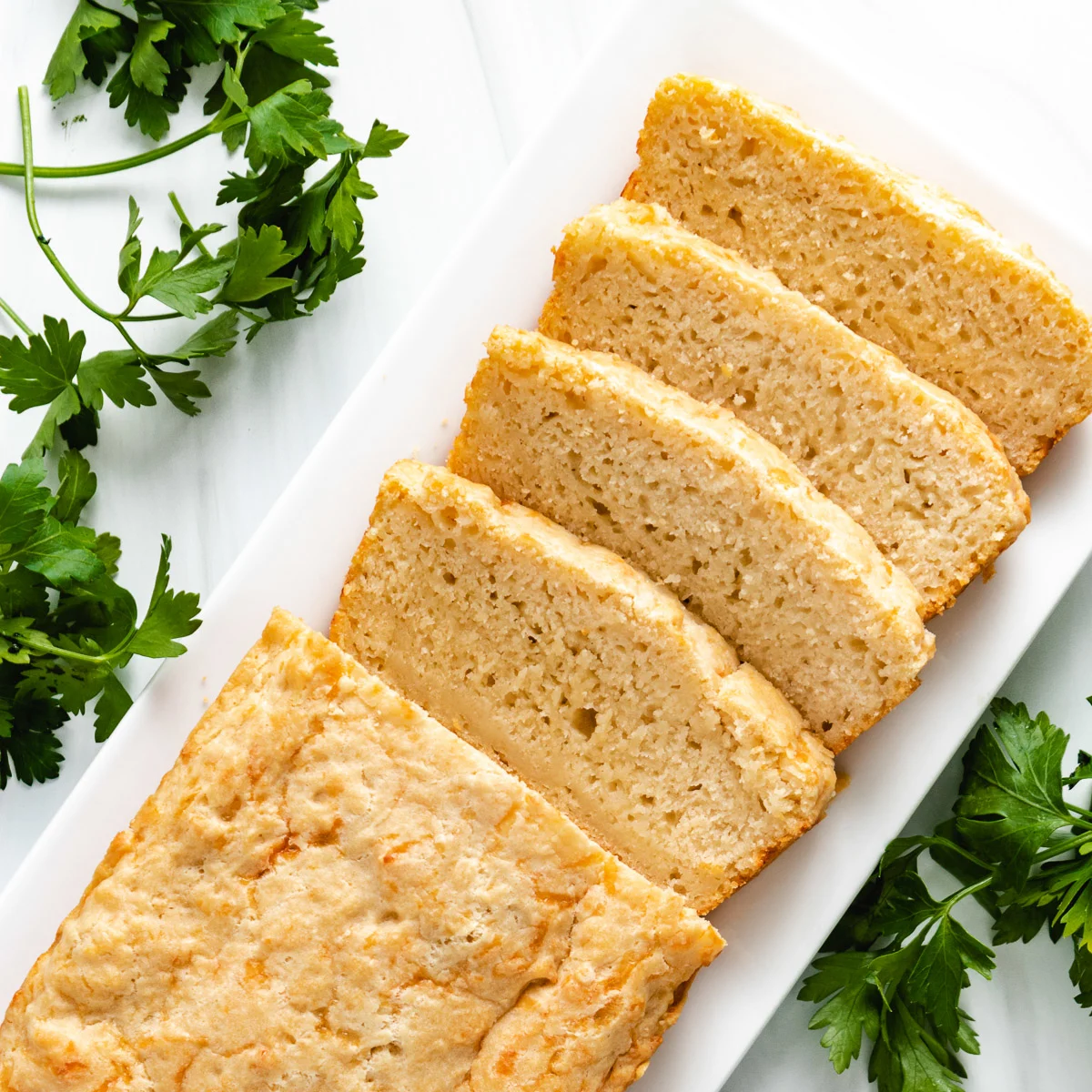 Top down view of beer bread on a white plate.