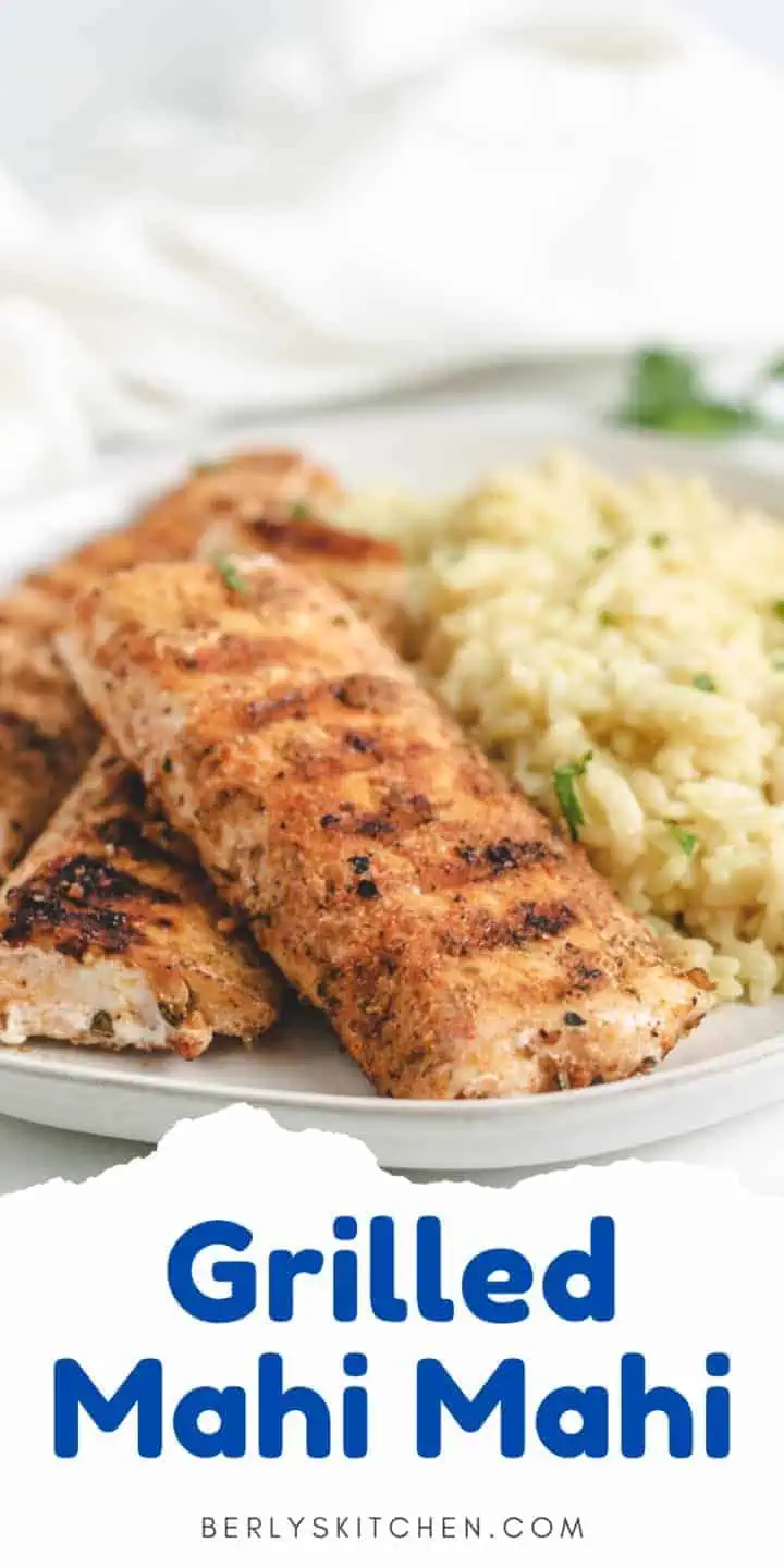 Grilled mahi mahi fillets on a plate with rice pilaf.