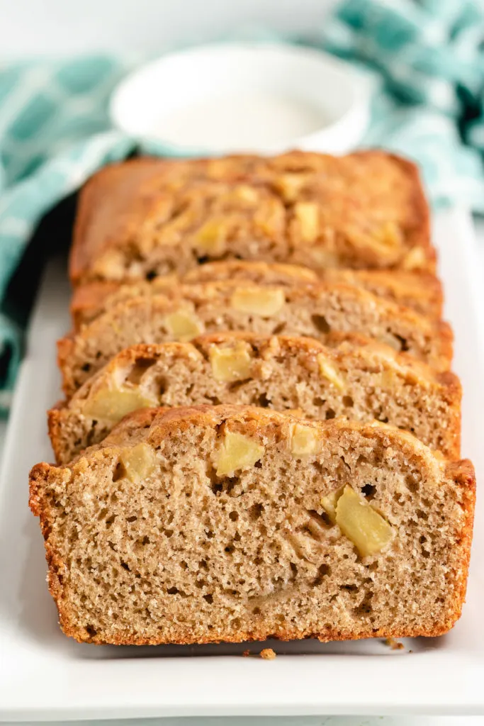 Sliced apple cinnamon bread on a white platter.