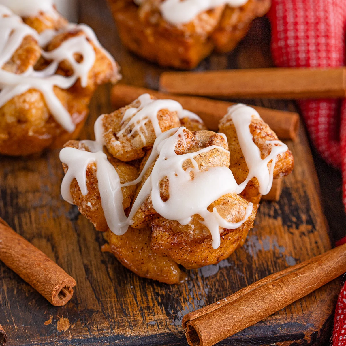 Cinnamon roll monkey bread roll with drizzle.