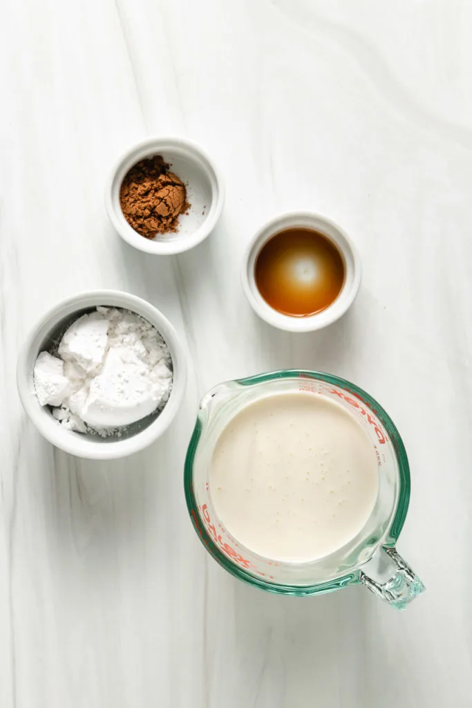 Top down view of ingredients for pumpkin spice whipped cream.