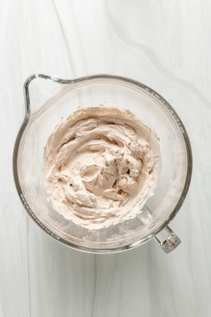 Top down view of pumpkin spice whipped cream in a bowl.