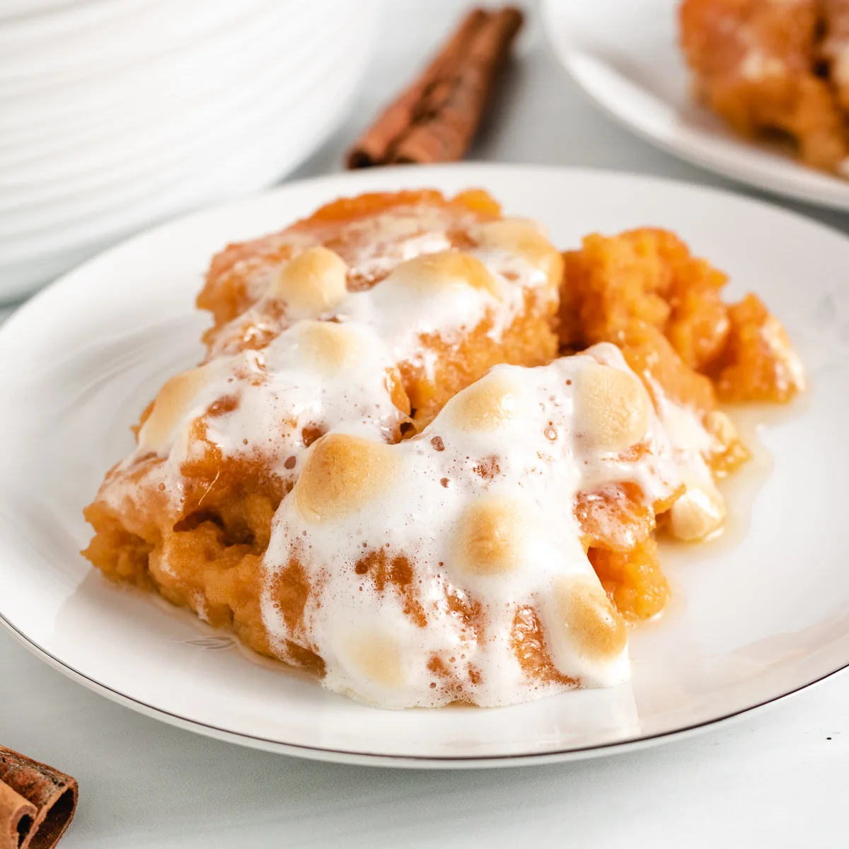 Scoop of sweet potato casserole topped with marshmallows.