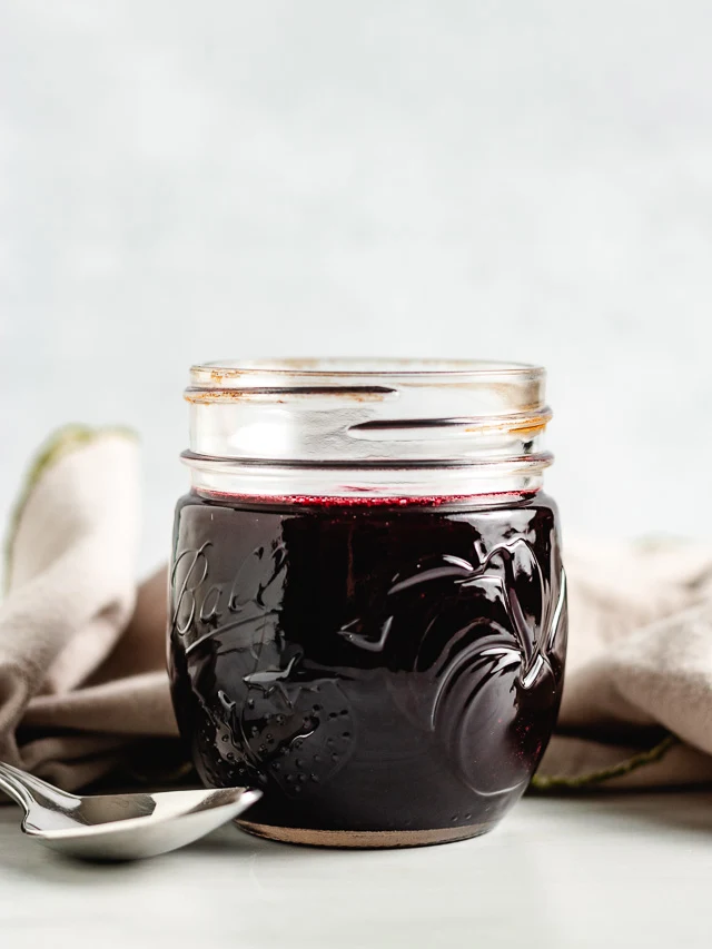 Mason jar filled with blackberry syrup.