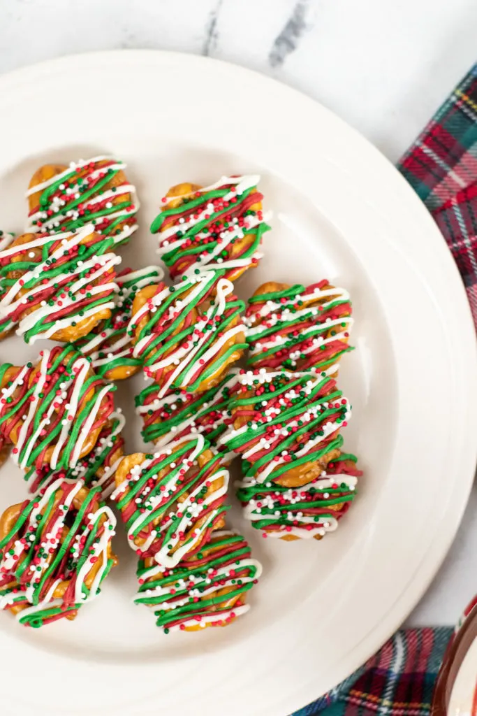 Top down view of a plate of chocolate drizzled pretzels.