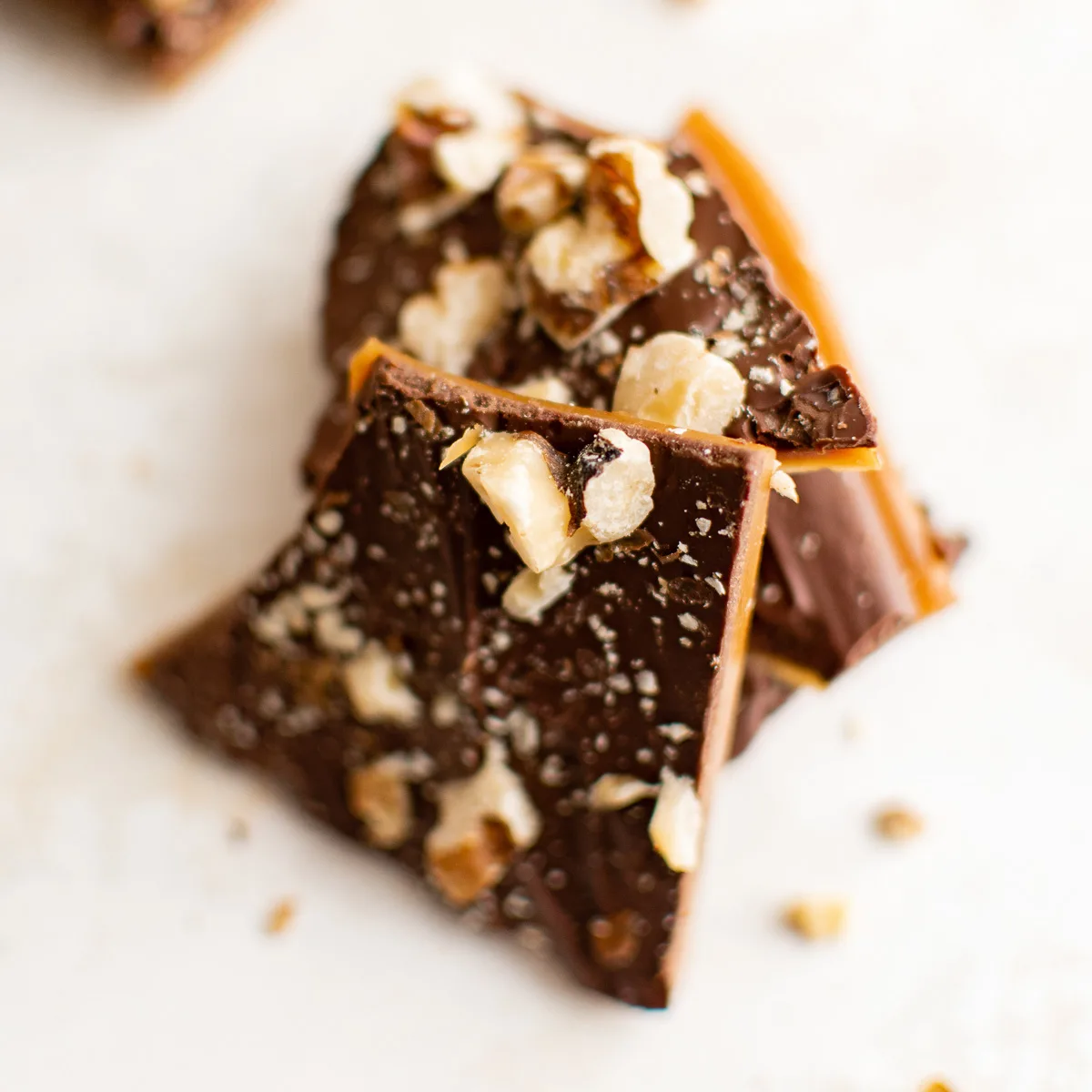 Close up view of pieces of toffee with nuts.