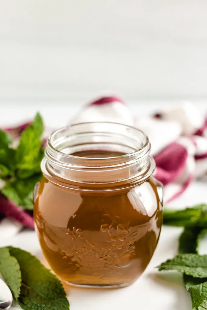 Mint syrup in a glass jar.