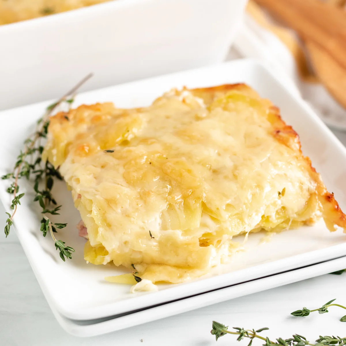 Two plates of cheesy potatoes au gratin.