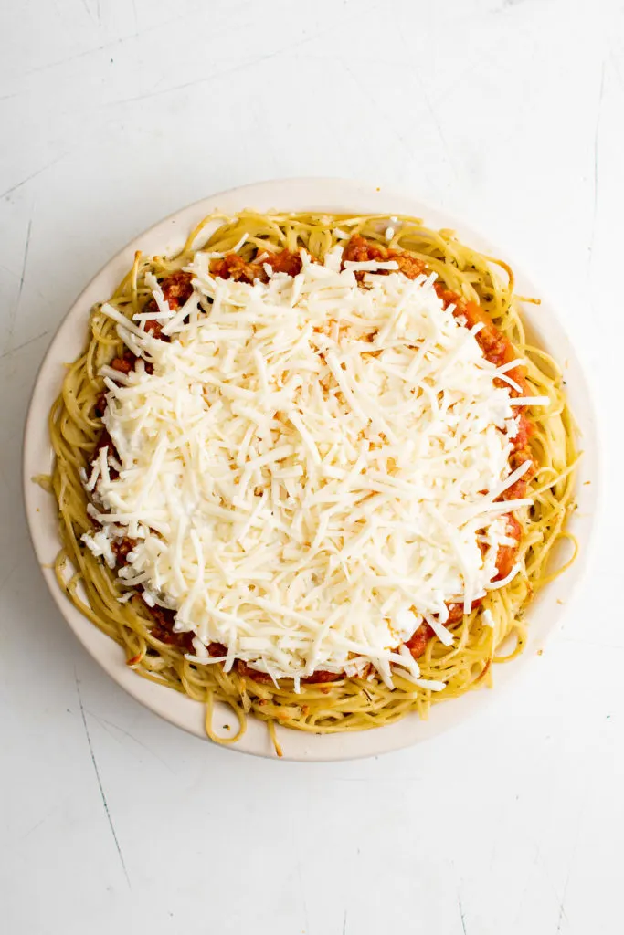 Top down view of mozzarella cheese on spaghetti bake.