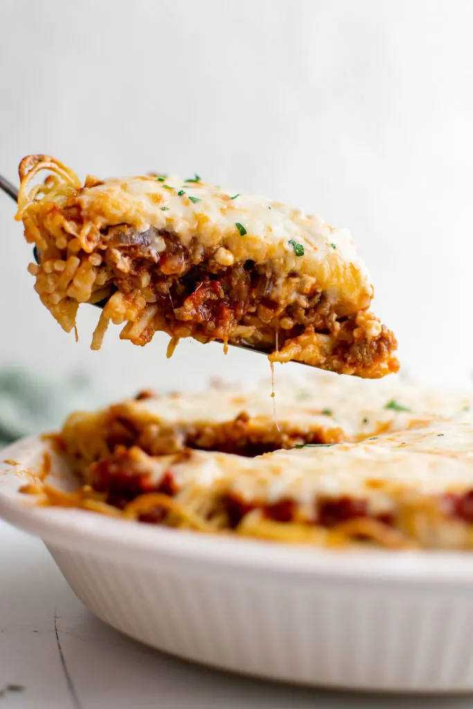 Slice of spaghetti pie on a spatula.