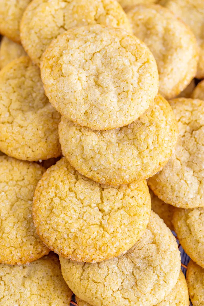 Fresh baked sugar cookies stacked in a pile.