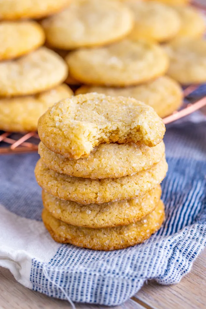 Tall stack of cookies on a blue linen.