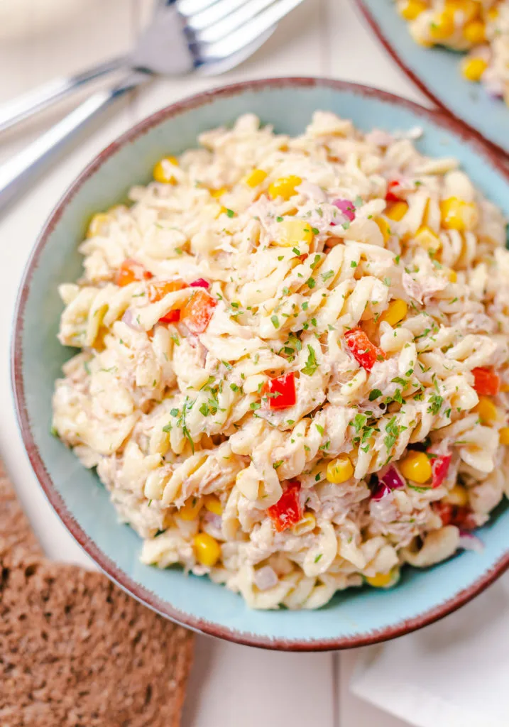 Close up view of pasta salad with fresh parsley.