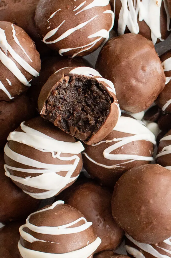 Close up view of brownie truffles with a bite taken out.