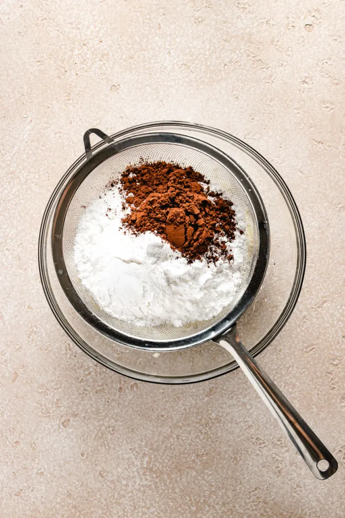 Powdered sugar and cocoa in a mesh sieve.