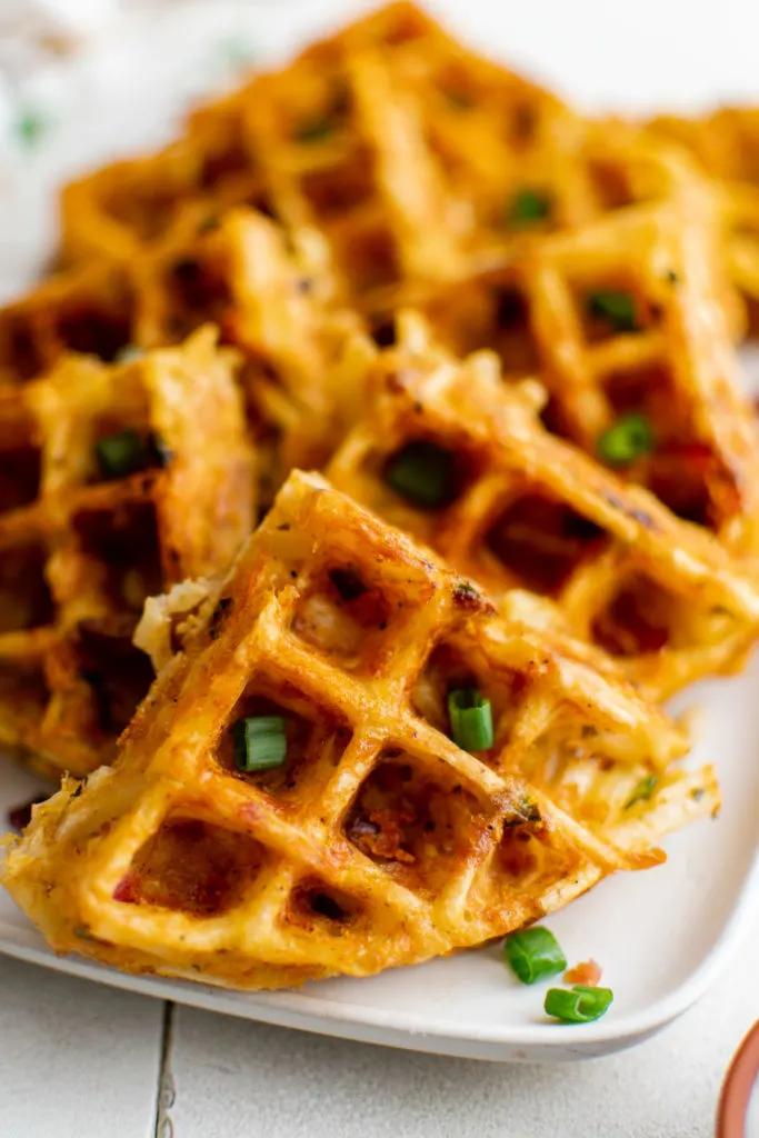 Several hash brown waffles on a serving platter.