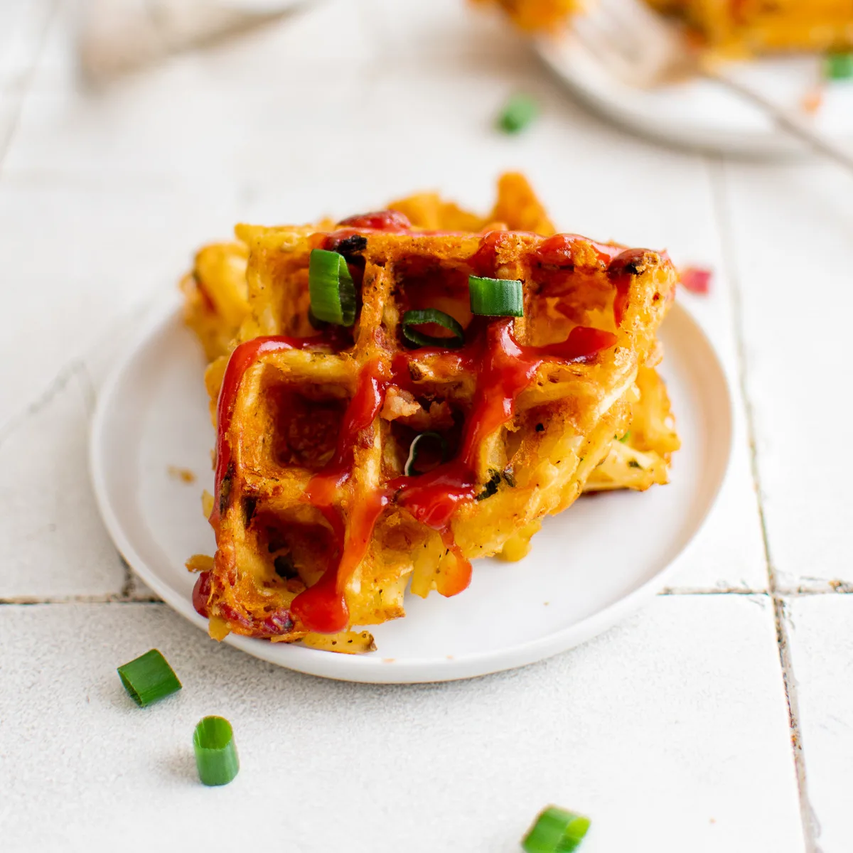 Two quarters of hash brown waffles on a plate.